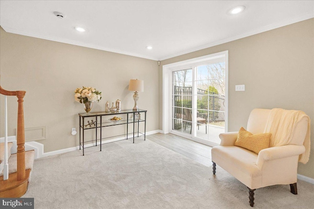 living area with ornamental molding, baseboards, and stairs