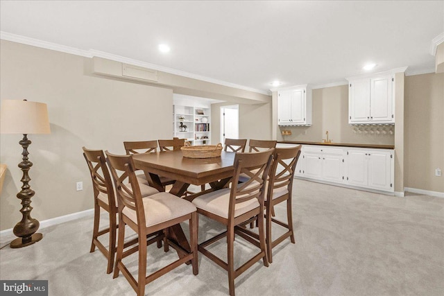 dining area featuring ornamental molding, recessed lighting, light carpet, and baseboards