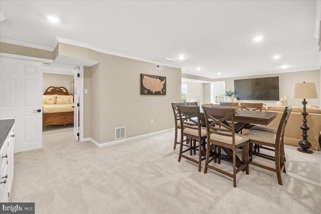 dining room featuring recessed lighting, light carpet, visible vents, baseboards, and ornamental molding