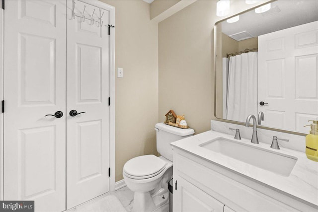 bathroom featuring marble finish floor, vanity, toilet, and baseboards