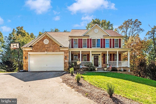 view of front of house with driveway, an attached garage, covered porch, a front lawn, and stone siding