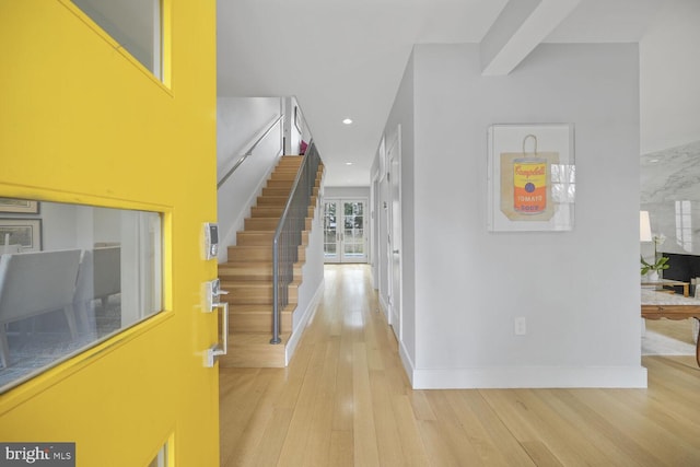 hall with baseboards, light wood finished floors, beam ceiling, recessed lighting, and stairs