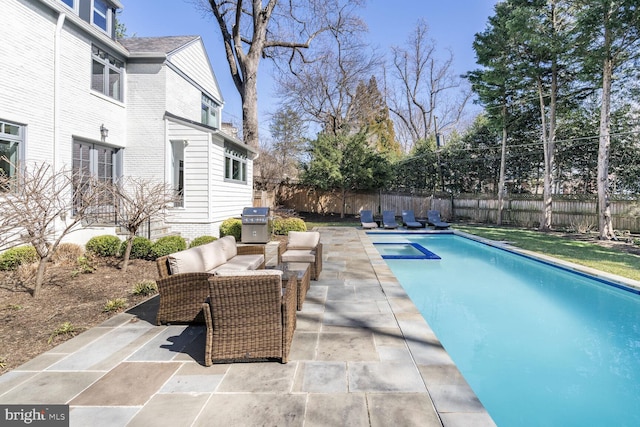 view of pool featuring grilling area, a fenced in pool, outdoor lounge area, a fenced backyard, and a patio area
