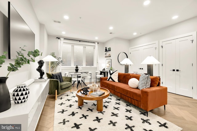 living area featuring recessed lighting and visible vents