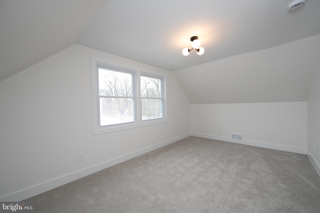 bonus room with visible vents, baseboards, carpet, and lofted ceiling