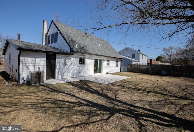 rear view of house featuring a yard, cooling unit, a patio, and fence