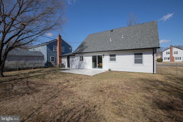 rear view of house featuring central AC, fence, a yard, a shingled roof, and a patio area