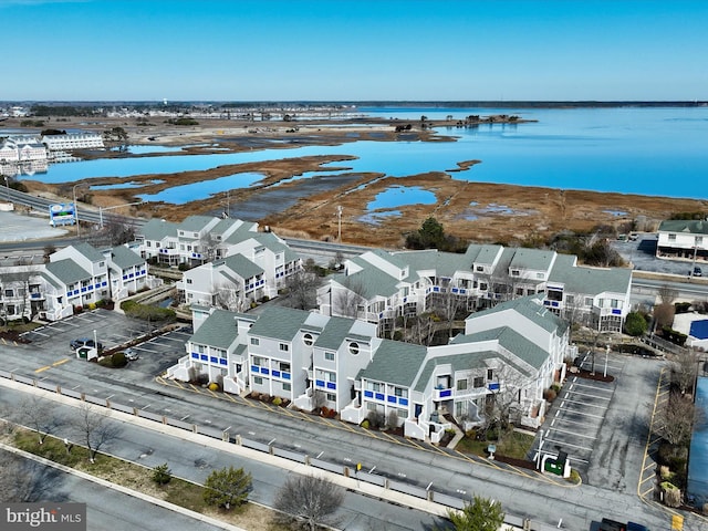 drone / aerial view with a residential view and a water view