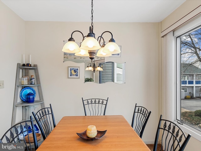 dining area featuring an inviting chandelier