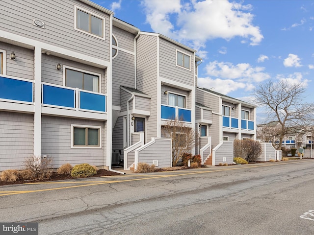 view of property with a residential view and central AC