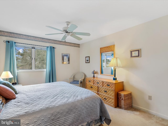 bedroom with light carpet, ceiling fan, and baseboards