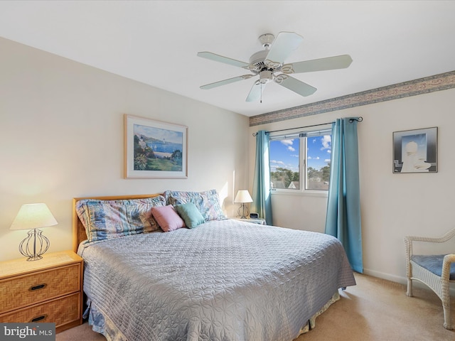 bedroom with baseboards, light carpet, and a ceiling fan