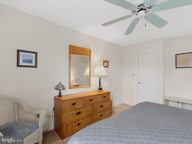 carpeted bedroom featuring a ceiling fan and baseboards