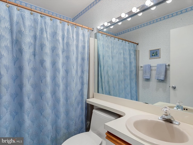 bathroom with a shower with shower curtain, toilet, and vanity