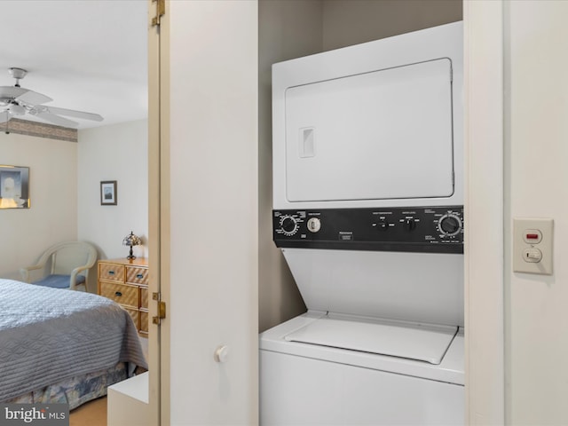 laundry room featuring ceiling fan, laundry area, and stacked washer / dryer