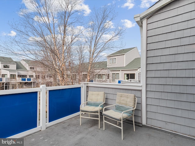 view of patio with a residential view and a balcony