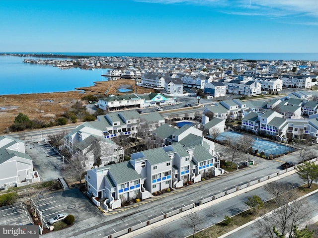 drone / aerial view with a residential view and a water view