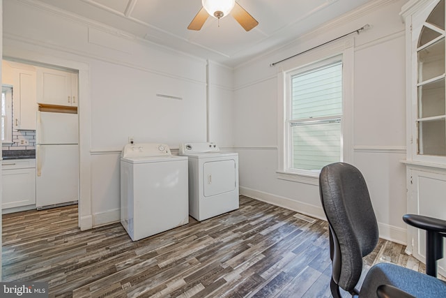 clothes washing area featuring ceiling fan, separate washer and dryer, dark wood-style flooring, baseboards, and ornamental molding