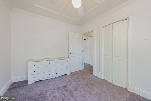 unfurnished bedroom featuring a ceiling fan, baseboards, ornamental molding, a closet, and carpet