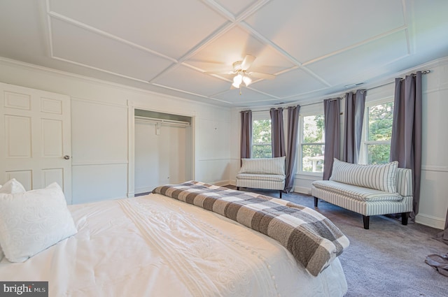 bedroom featuring baseboards, coffered ceiling, ceiling fan, carpet floors, and a closet