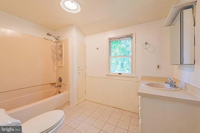 bathroom featuring tile patterned flooring, toilet, a wainscoted wall, vanity, and tub / shower combination