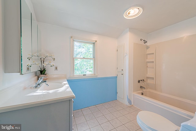 bathroom featuring wainscoting, toilet, tile patterned flooring, vanity, and shower / bathing tub combination