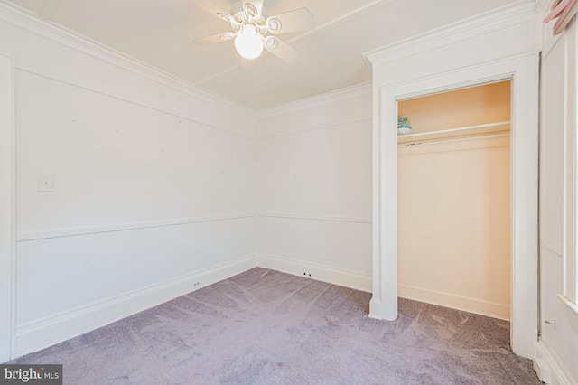 unfurnished bedroom with a ceiling fan, carpet flooring, crown molding, and baseboards