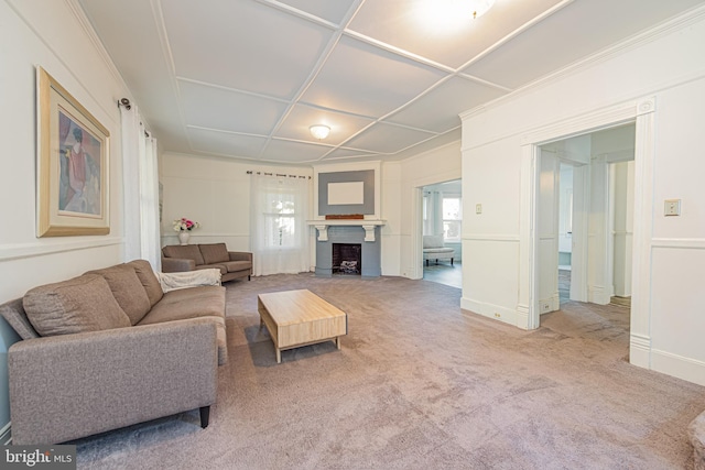 living area featuring a fireplace with flush hearth and carpet flooring