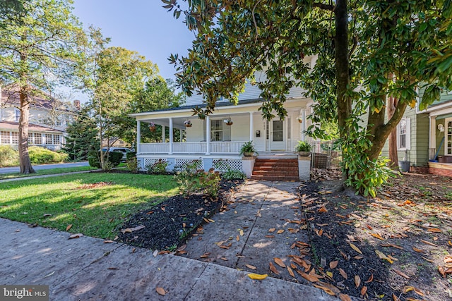 view of front of home with a front yard and covered porch