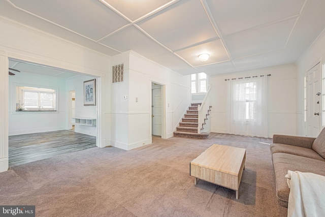 living area featuring carpet, stairs, and visible vents