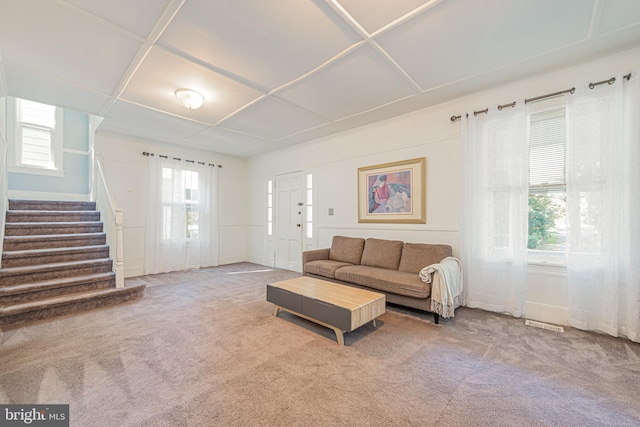 living room featuring carpet floors and stairway