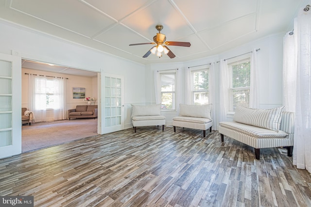 unfurnished room featuring a ceiling fan, coffered ceiling, and wood finished floors