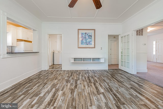 unfurnished living room featuring crown molding, visible vents, ceiling fan, wood finished floors, and washer / dryer