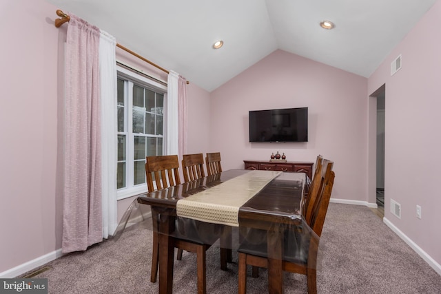 dining room featuring vaulted ceiling, carpet floors, visible vents, and baseboards