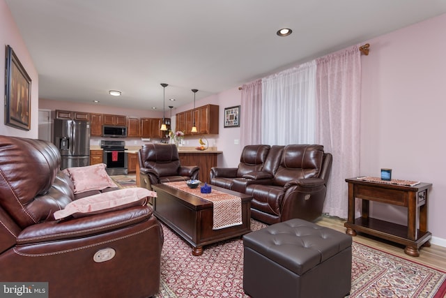 living room featuring light wood-type flooring and recessed lighting