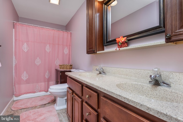 bathroom featuring toilet, a sink, and a shower with shower curtain