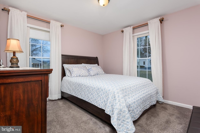 carpeted bedroom featuring baseboards