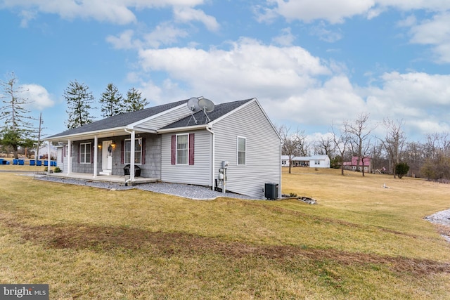 view of side of home featuring a yard and a porch