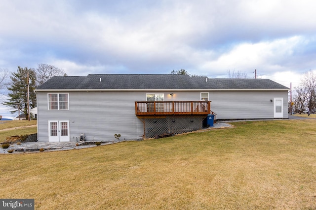 rear view of house with a yard, french doors, and a wooden deck