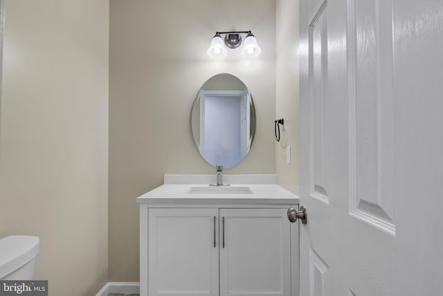 bathroom featuring toilet and vanity