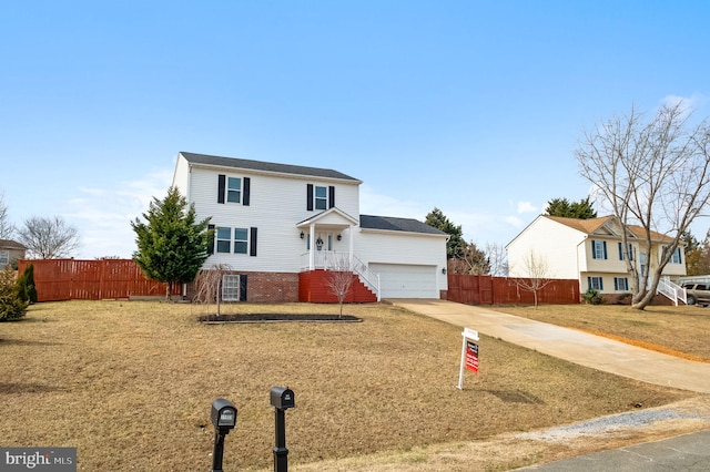 traditional-style house with a garage, fence, and driveway