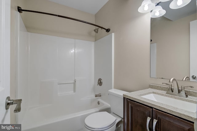 bathroom featuring  shower combination, vanity, and toilet