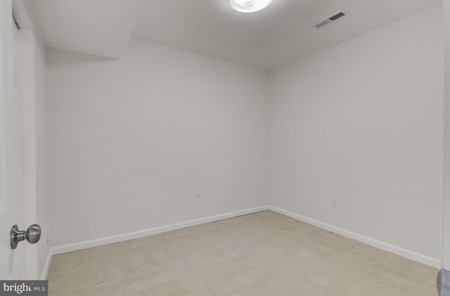 unfurnished room with visible vents and baseboards