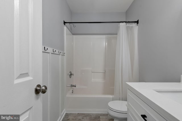 bathroom featuring vanity, toilet, and shower / bath combo with shower curtain