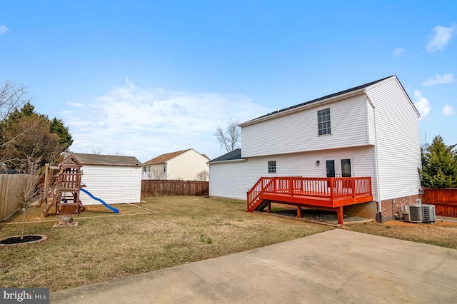 rear view of house featuring central AC unit, a fenced backyard, a yard, a wooden deck, and a playground