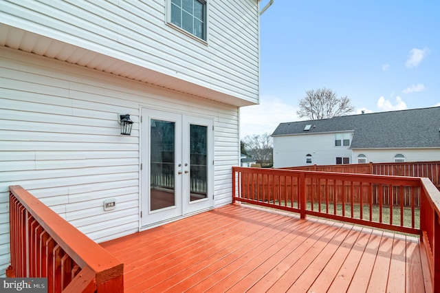 wooden deck featuring fence and french doors