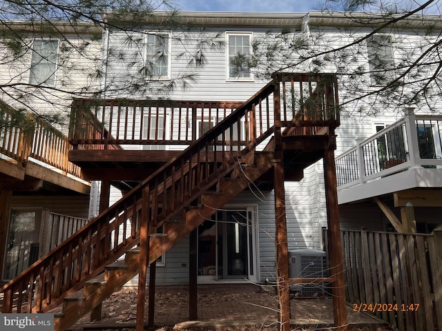 rear view of house featuring cooling unit, a deck, and stairs