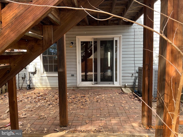 entrance to property with a patio and cooling unit