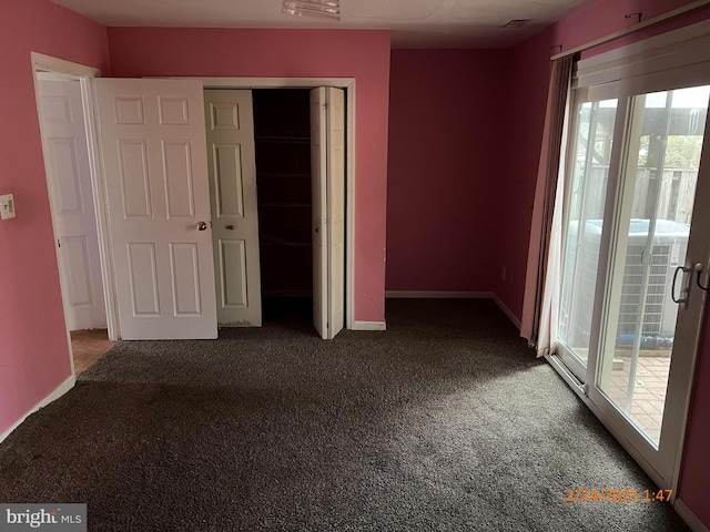 unfurnished bedroom featuring carpet floors, multiple windows, a closet, and access to exterior