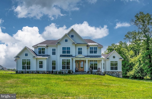 view of front of house featuring metal roof, a standing seam roof, and a front yard